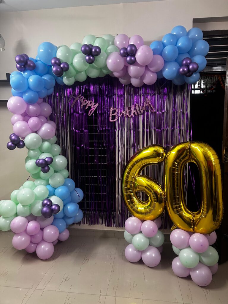 Luxury royal glam birthday balloon arch setup with chrome and confetti balloons