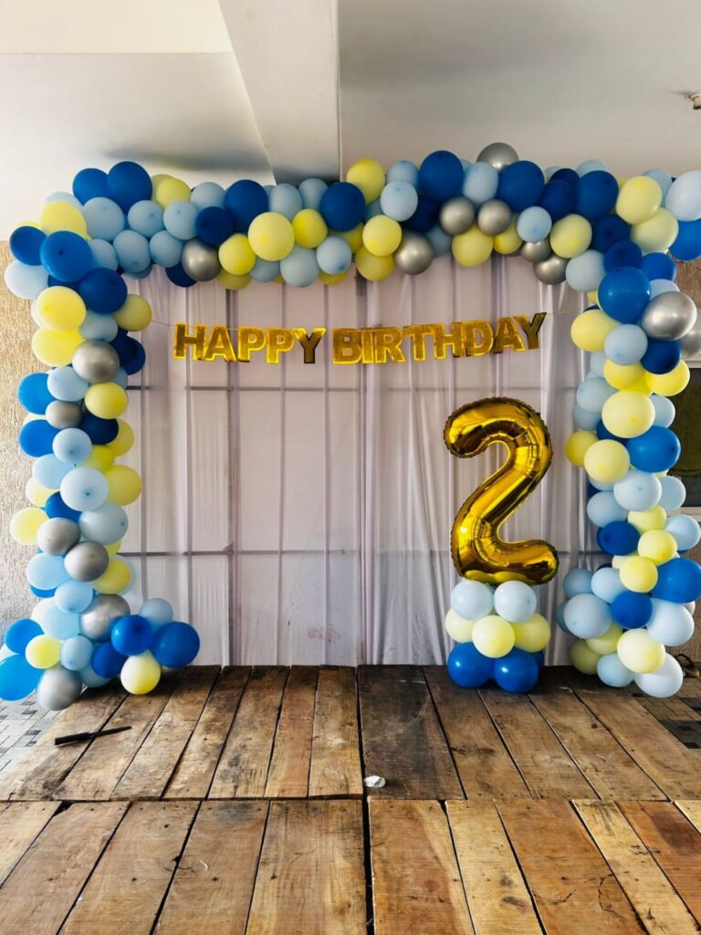 “Elegant event decoration setup with balloons, flowers, and warm lighting created by Vruddhi Events a Trusted Event Planners.