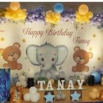 Helium balloon decoration Hyderabad for jungle theme birthday party with pastel balloons, elephant backdrop, and custom name display by Vruddhi Events.