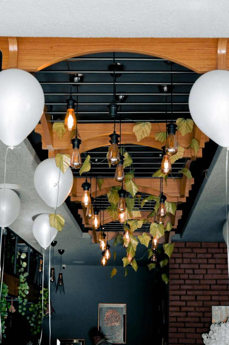 Modern interior featuring hanging Edison bulbs and white balloons for elegant decor.