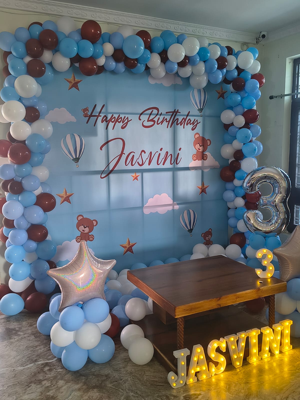 irthday balloon decoration with customized backdrop and LED name letters.